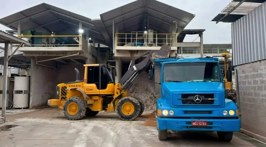 Pá carregadeira e caminhão caçamba da SB carregando lama numa marmoraria